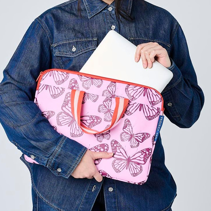Someone placing a laptop in the Butterfly Laptop Case.
- Project Ten