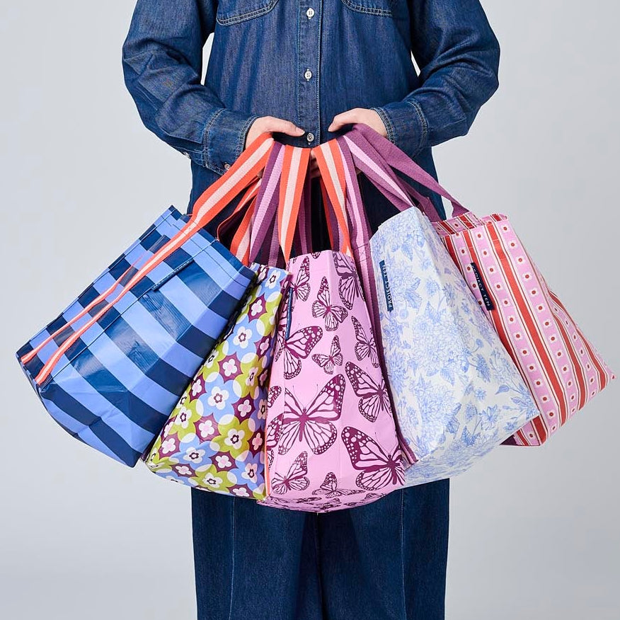 Someone holding 5 Shopper Totes in Wallpaper, Butterfly, Toile, Mosaic & Blue Stripe.
- Project Ten