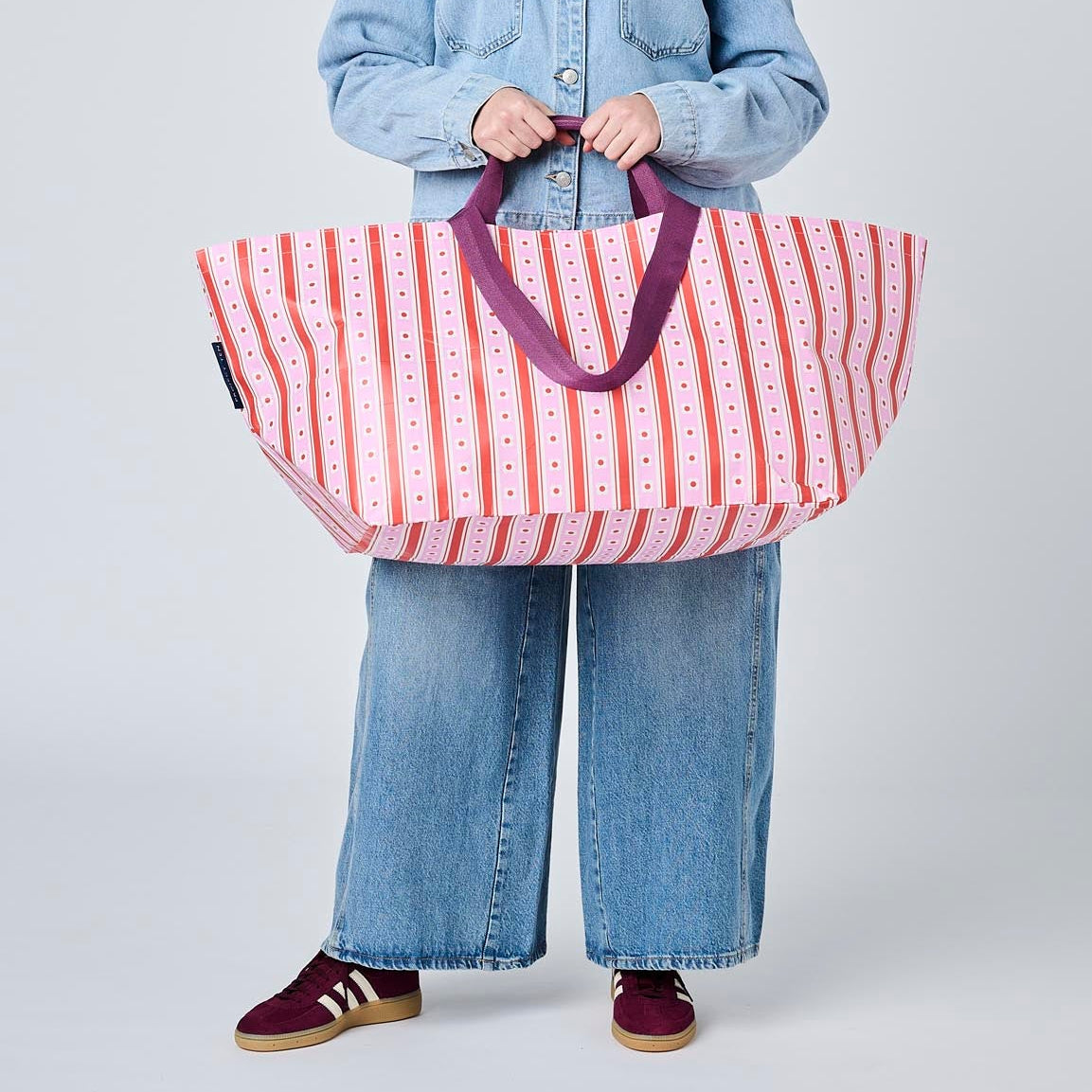Someone holding the Oversized Tote using the soft woven handles, in Wallpaper.
- Project Ten