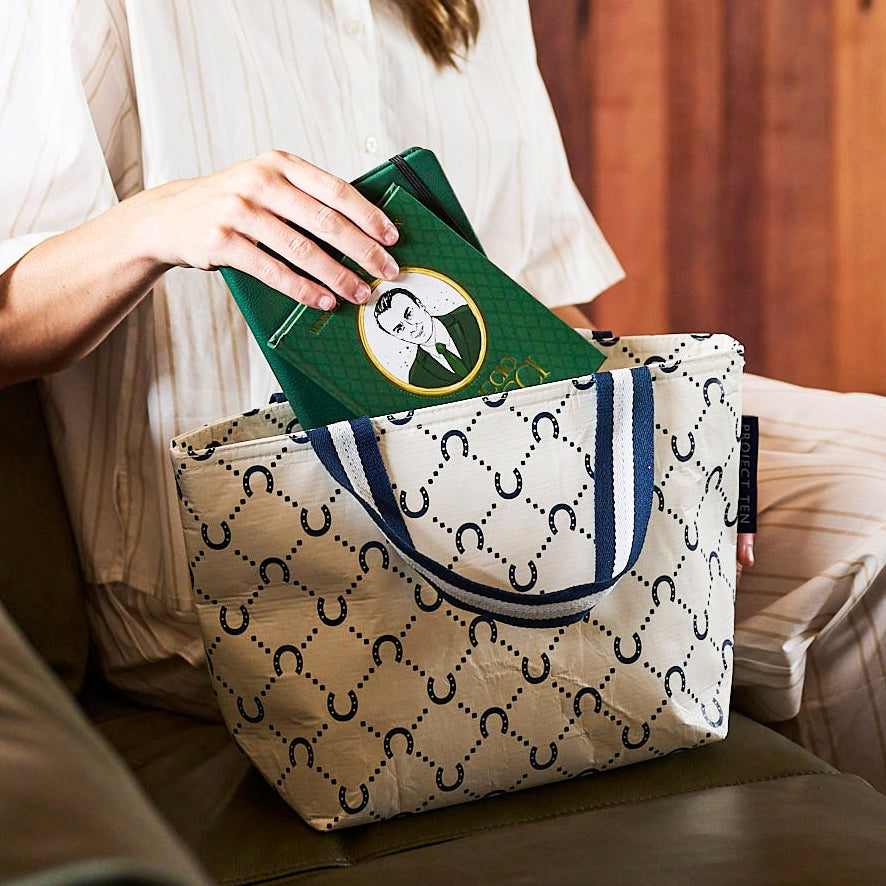 Someone placing books into our Mini Tote – Navy Horseshoe - Project Ten