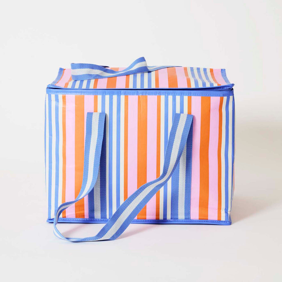 Our Capri Stripe Large Insulated Tote, a large boxy cooler bag in vertical stripes of pink, orange, blue and ecru, with a fold-over zip lid, long blue and ecru striped shoulder straps and a short blue and ecru striped top handle.