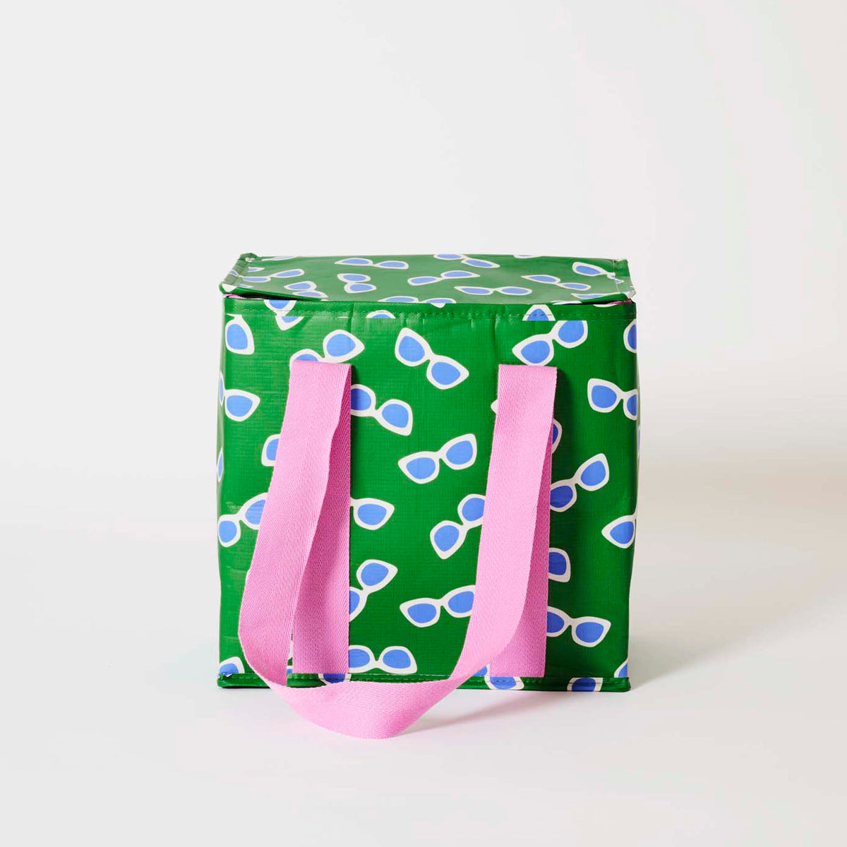 Our Sunglasses Medium Insulated Tote, in green with a scattered print of ecru framed sunglasses with blue lenses, a fold-over zip lid and long pink straps.