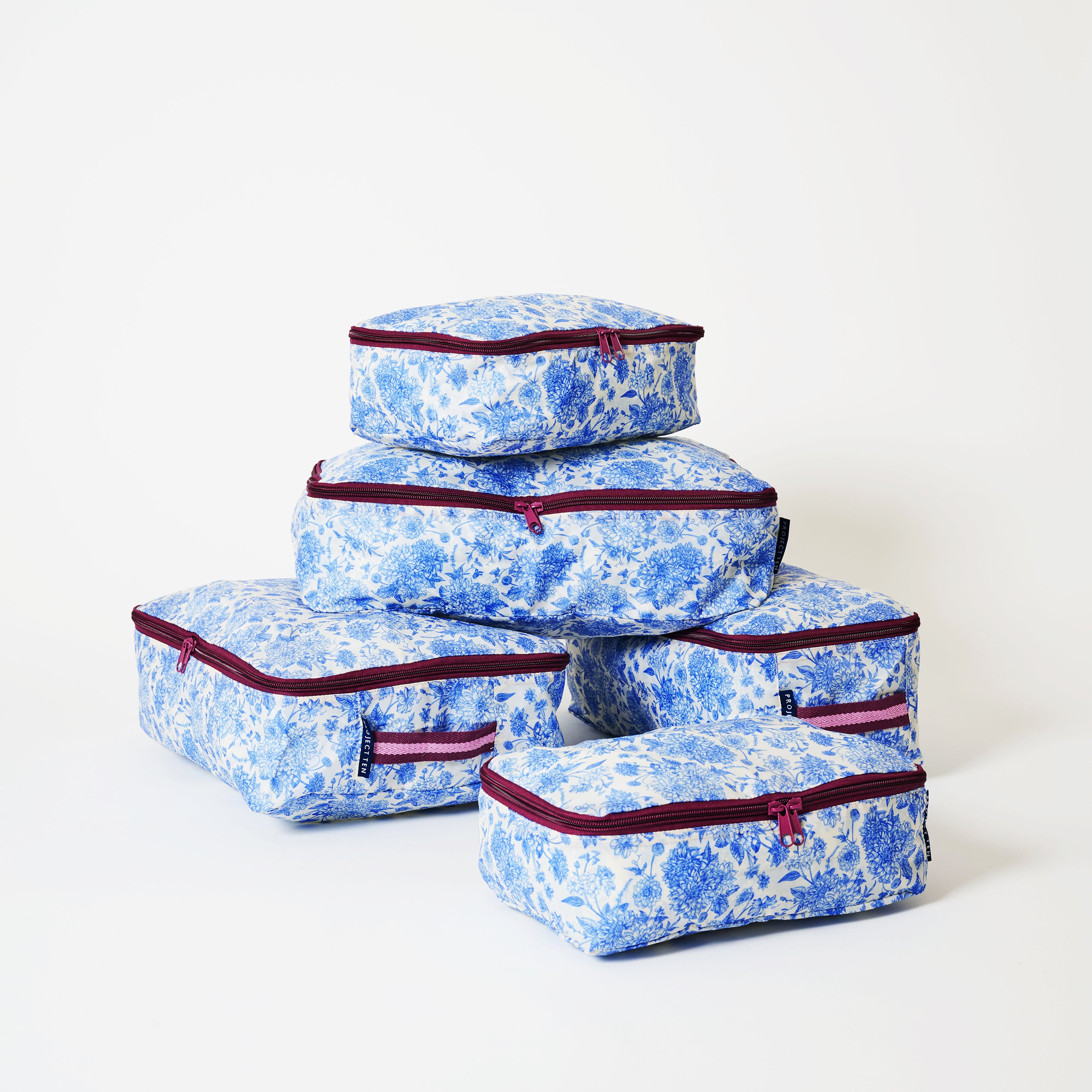 A set of 5 packing cubes with soft woven handles, in Toile.
- Project Ten