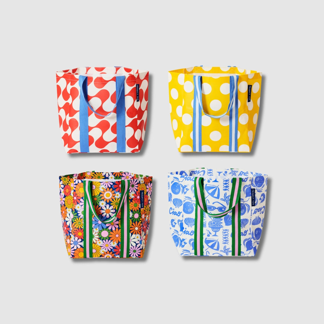 Our Summer 26 Prints Shopper Tote Bundle, a set of four Shopper Totes in Red Ripple, Yellow Polka Dot, Coastal Floral and Feast prints, each with matching carry handles.