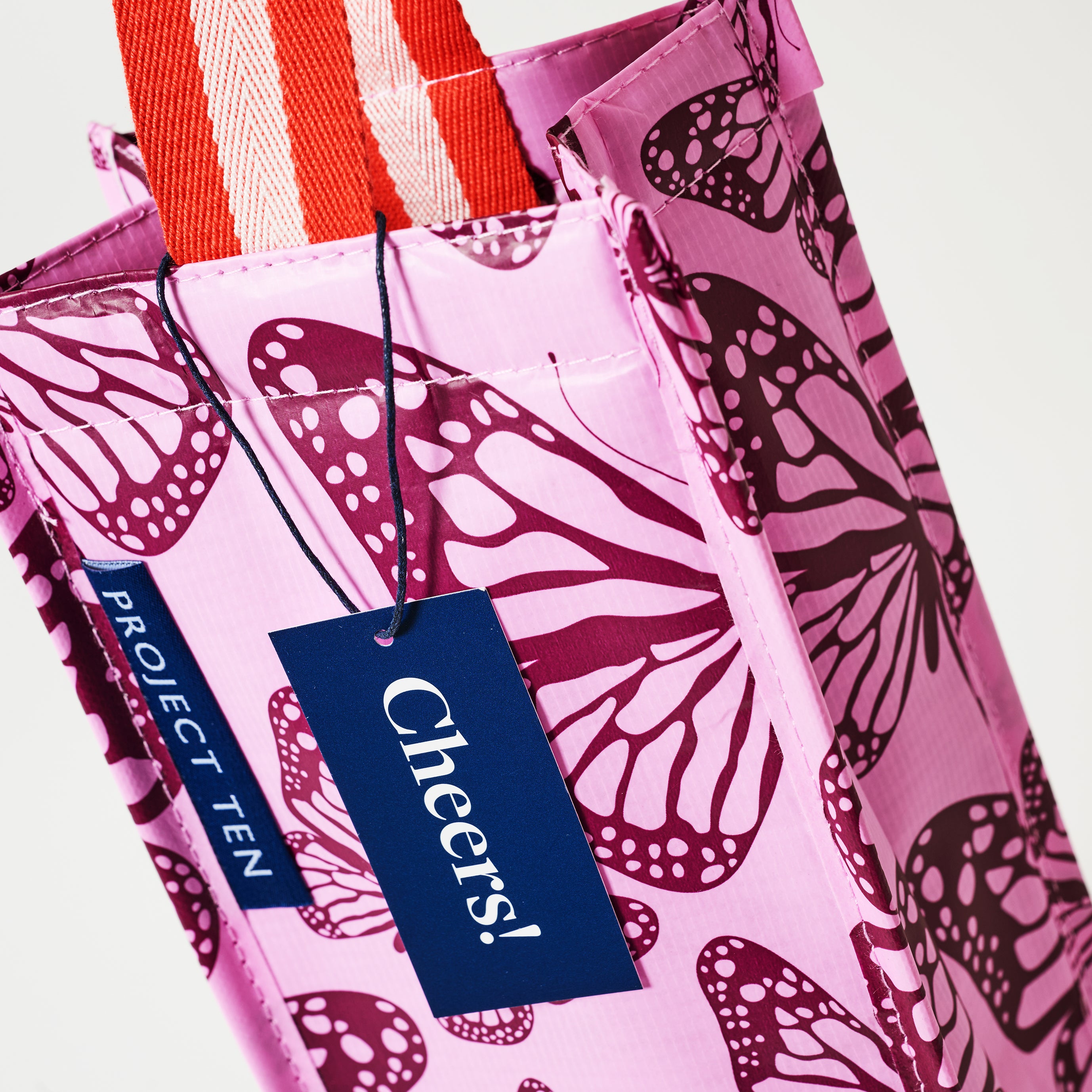 Close up of the Wine Bag and soft woven handle in Butterfly.
- Project Ten