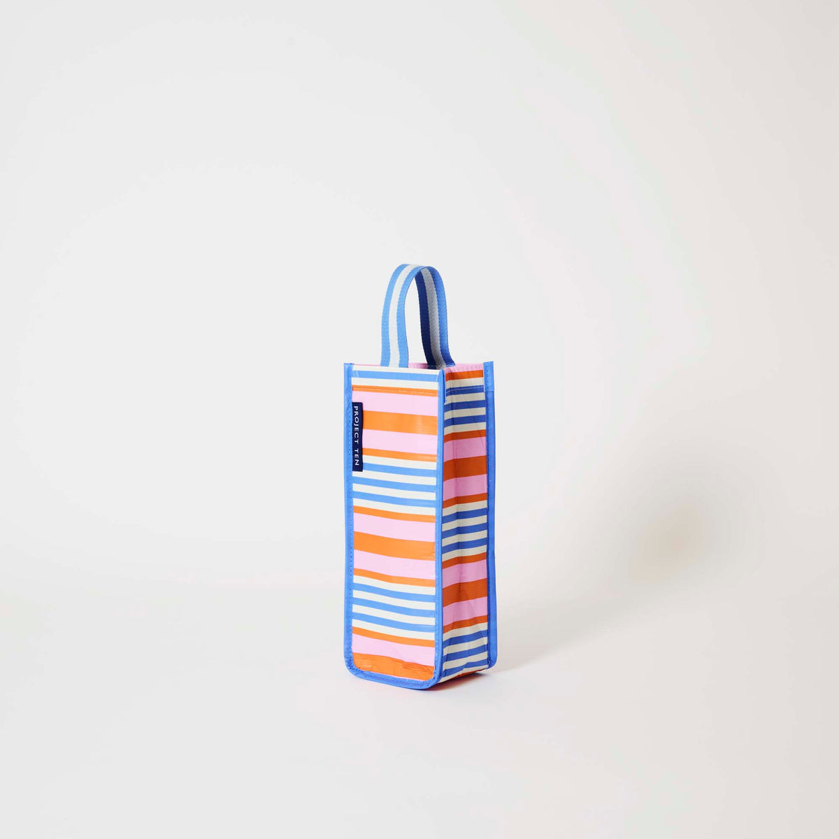 Our Capri Stripe Wine Bag, a tall narrow bottle bag in pink, orange, blue and ecru horizontal stripes with a blue trim and a single blue and ecru striped carry handle.