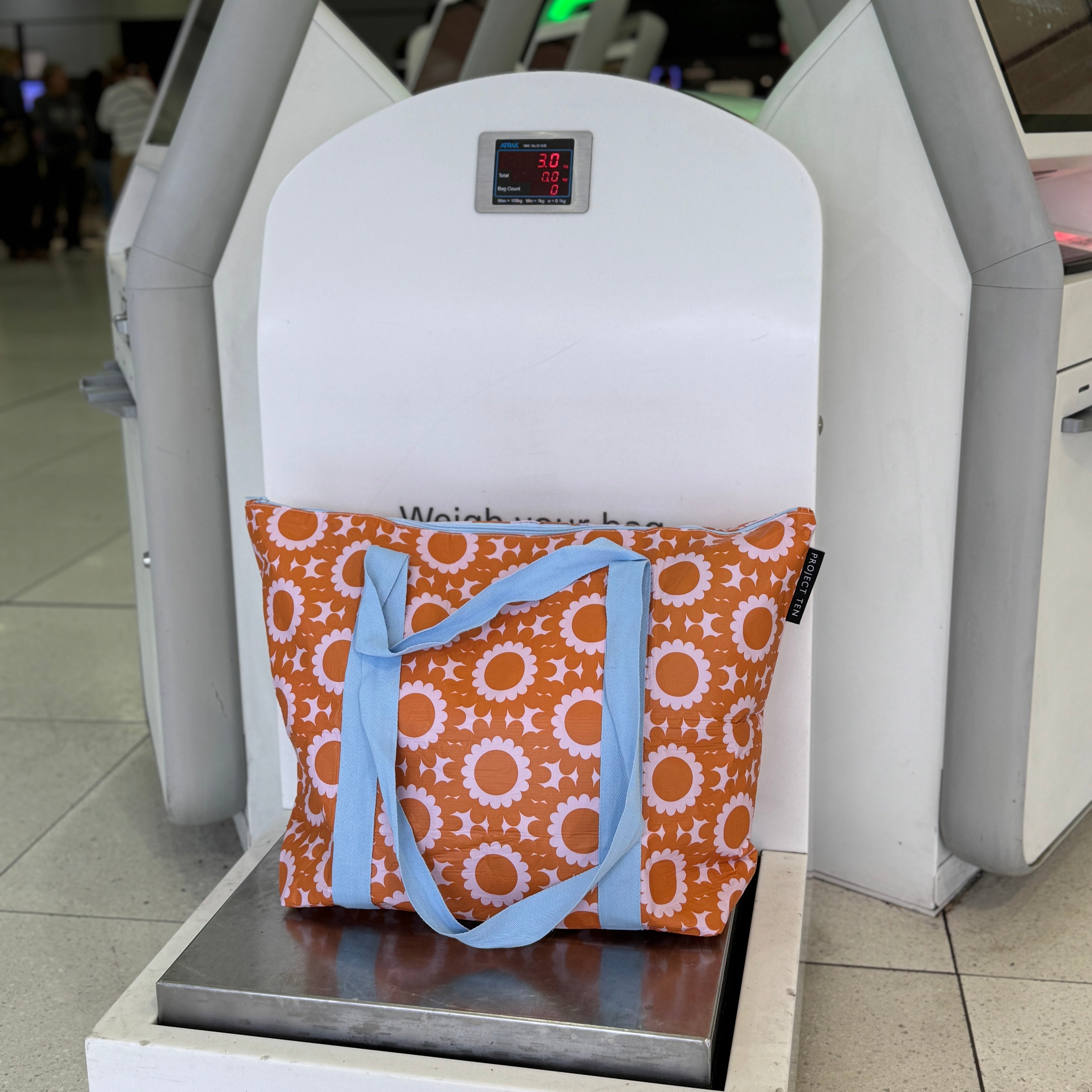 Project Ten Zip Medium Tote on bag scales at airport