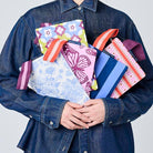 A person holding our Mini Zip Pouches. 
Wallpaper, Butterfly, Toile, Mosaic & Blue Stripe. 
- Project Ten