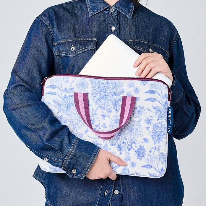 Someone placing a laptop in the Toile Laptop Case.
- Project Ten