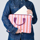 Someone placing a laptop in the Wallpaper laptop case. 
- Project Ten