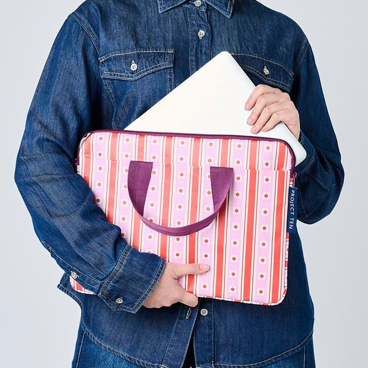 Someone placing a laptop in the Wallpaper laptop case. 
- Project Ten
