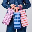 Someone holding 3 Wine Bags. 
Butterfly, Blue Stripe & Wallpaper. 
- Project Ten