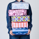 Someone holding 5 Takeaway Bags in Wallpaper, Butterfly, Toile, Mosaic & Blue Stripe. 
- Project Ten