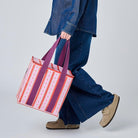 Someone holding the Medium Insulated Tote using the soft woven handles. 
 Project Ten