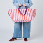 Someone holding the Oversized Tote using the soft woven handles, in Wallpaper.
- Project Ten 