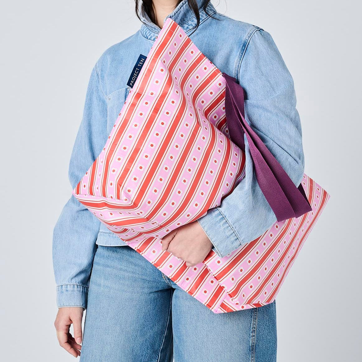 Someone holding the Medium Tote in Wallpaper. 
- Project Ten