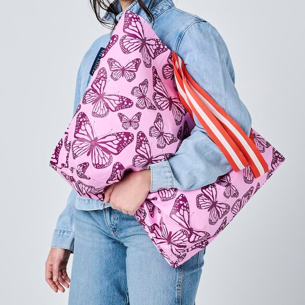 Someone holding the Medium Tote with soft woven handles, in Butterfly. 
- Project Ten