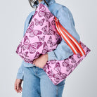 Someone holding the Medium Tote with soft woven handles, in Butterfly. 
- Project Ten