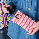 Someone placing sunglasses in the top pocket of the glasses case. Reading glasses are in the front pocket. 
- Project Ten