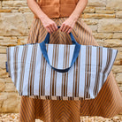 Someone holding the Oxford Stripe Oversized Tote using the double handles – 

- Project Ten