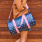 Barrel Bag – Confetti. Person holding barrel bag using shoulder strap. - Project Ten