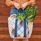 Someone holding the shopper Tote Splice – Country Plaid merged with Navy Horseshoe - Project Ten