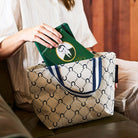 Someone placing books into our Mini Tote – Navy Horseshoe - Project Ten