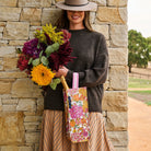 Someone holding the Wine Bag with a bottle of champagne in it – Hydrangea - Project Ten