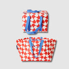 Our Red Ripple Beach Large Shopping Bundle, a zip-top Large Insulated Tote and Oversized Tote in a bold geometric wave print of red and ecru, each with blue carry handles.