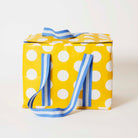 Our Yellow Polka Dot Large Insulated Tote, a large boxy cooler bag in bright yellow with ecru polka dots, with a fold-over zip lid, long blue and ecru striped shoulder straps and a short blue and ecru striped top handle.