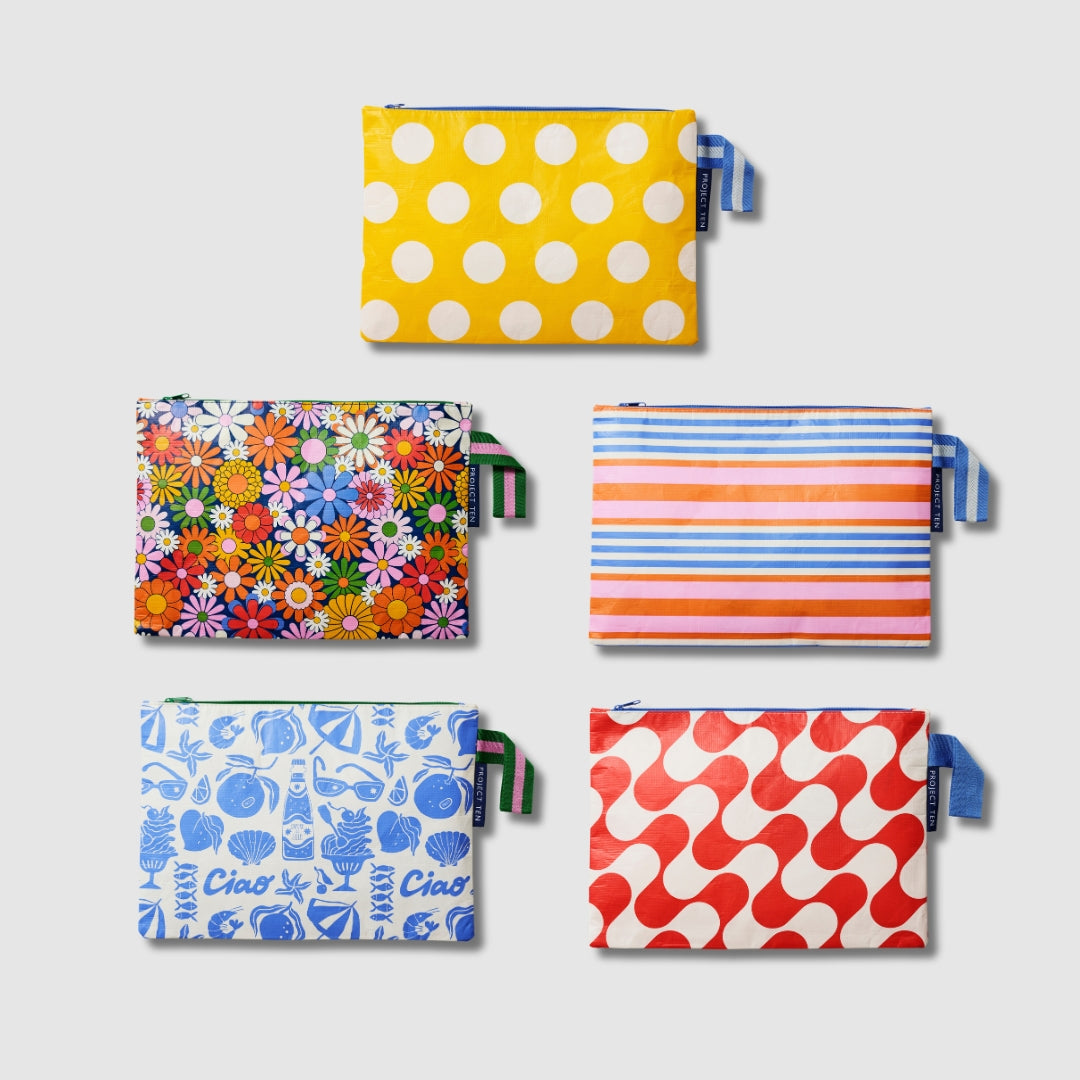 Our Summer 26 Prints Large Zip Pouch Bundle, a set of five Large Zip Pouches in Yellow Polka Dot, Coastal Floral, Capri Stripe, Feast and Red Ripple prints, each with a matching loop tab.