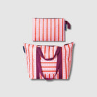 Image shows our Zip Medium Tote with luggage band below our Large Zip pouch, both in Wallpaper. 
- Project Ten