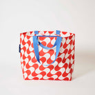 Our Red Ripple Medium Tote in a red and ecru wave print with blue straps, shown open against a plain background.