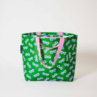 Our Sunglasses Medium Tote in green with a scattered print of ecru framed sunglasses with blue lenses, and pink straps, shown open against a plain background.