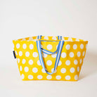 Our Yellow Polka Dot Oversized Tote in bright yellow with ecru polka dots and blue and white striped straps, shown open against a plain background.