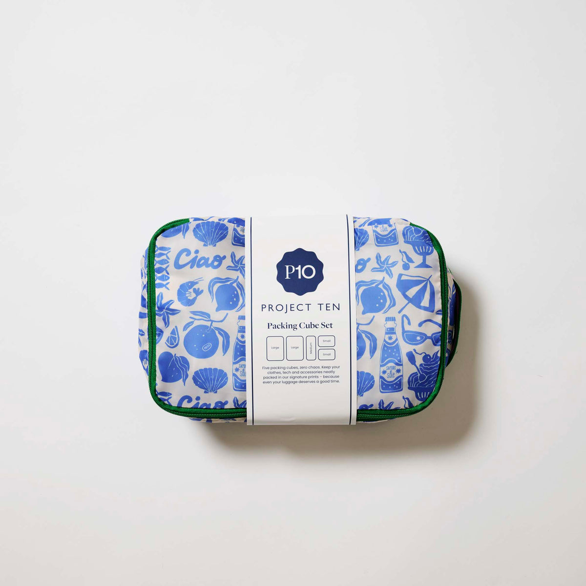 Our Feast Packing Cubes, a set of five zip-up packing cubes in different sizes, in an ecru base with a blue seaside print of shells, oranges, soda bottles, sunglasses and "Ciao" lettering, with green zips and green and pink striped carry handles.