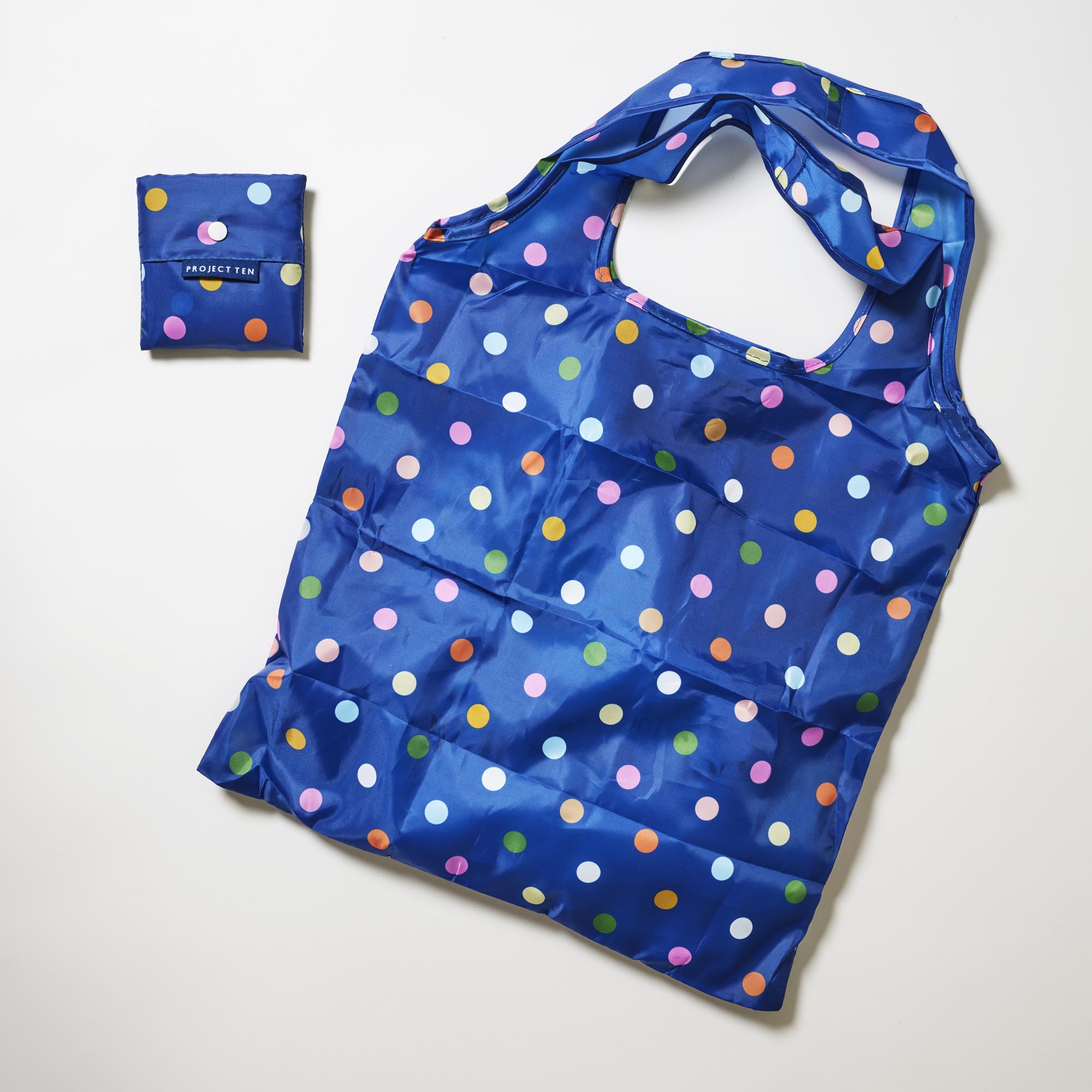 Pocket Shopper – Confetti - Project Ten
Image shows the pocket shopper folded up and fully open. 
Polka dots on navy background