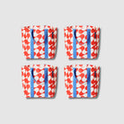 Our Red Ripple Shopper Tote Bundle, a set of four Shopper Totes in a bold geometric wave print of red and ecru, each with blue carry handles.