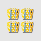 Our Yellow Polka Dot Shopper Tote Bundle, a set of four Shopper Totes in bright yellow with large ecru polka dots, each with blue and ecru striped carry handles.