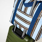 Zip Medium Tote sitting on top of suitcase using the luggage band– Oxford Stripe 

- Project Ten
