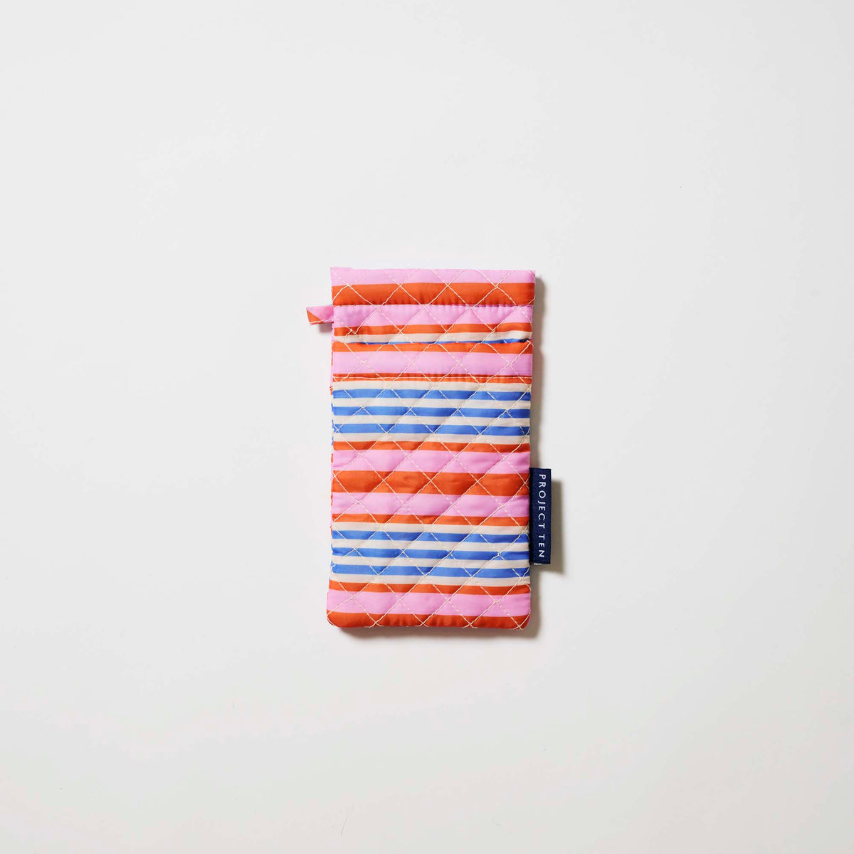Our Capri Stripe Double Glasses Case, a soft quilted glasses case in pink, orange, blue and ecru horizontal stripes, with a squeeze-top opening and a small loop tab.