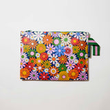 Our Coastal Floral Large Zip Pouch, a flat rectangular pouch covered in bright retro daisies in orange, pink, yellow and blue on a navy background, with a green zip and green and pink striped handle.