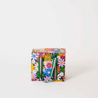 Our Coastal Floral Mini Insulated Tote, a small boxy cooler bag covered in bright retro daisies in orange, pink, yellow and blue on a navy background, with a fold-over zip lid and short green and pink striped carry handles.