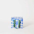 Our Feast Mini Insulated Tote, a small boxy cooler bag in a blue and ecru print of shells, gelato, soda bottles, sunglasses and the word "Ciao", a fold-over zip lid and short green and pink striped carry handles.