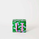 Our Sunglasses Mini Insulated Tote, a small boxy cooler bag in green with a scattered print of ecru framed sunglasses with blue lenses, a fold-over zip lid and short pink carry handles.