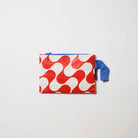 Red Ripple Mini Zip Pouch

Our Red Ripple Mini Zip Pouch, a small rectangular pouch in a red and ecru wave print with a blue zip and blue handle.