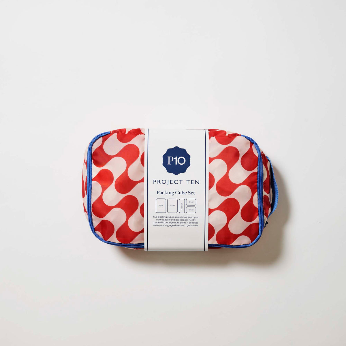 Our Red Ripple Packing Cubes, a set of five zip-up packing cubes in different sizes, in a bold geometric wave print of red and ecru, with blue zips and blue carry handles.
