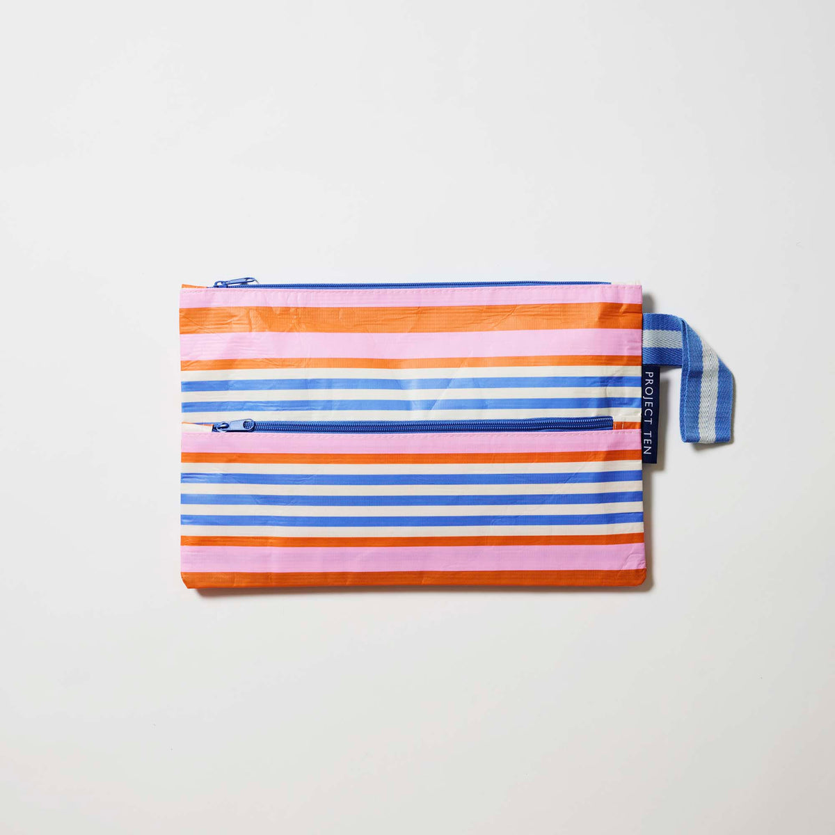 Our Capri Stripe Pencil Case, a flat rectangular case in horizontal stripes of pink, orange, blue and ecru, with two blue zip compartments and a blue and ecru striped handle.