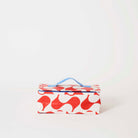Our Red Ripple Takeaway Bag, a rectangular insulated bag in a red and ecru wave print with a zip closure and a single blue carry handle.