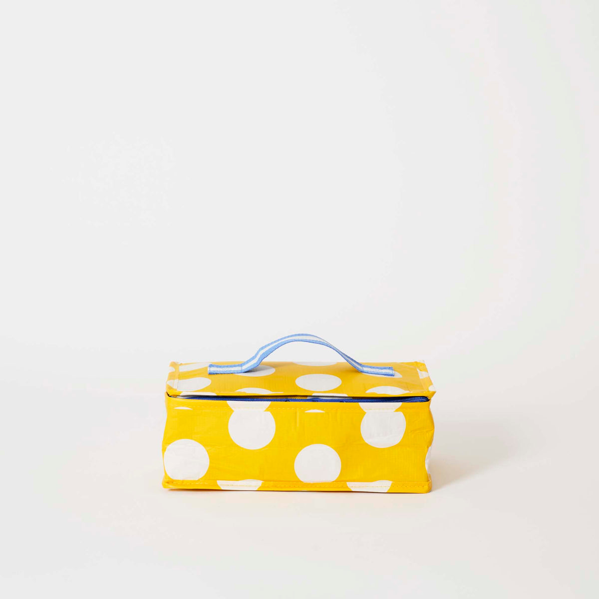Our Yellow Polka Dot Takeaway Bag, a rectangular insulated bag in bright yellow with ecru polka dots, a zip closure and a single blue and ecru striped carry handle.